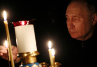 FILE PHOTO: Russian President Putin lights a candle in memory of the victims of the Crocus City Hall attack, in Moscow Region