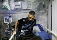 Palestinian former nurse sits at a UAE makeshift hospital on a ship in Al Arish